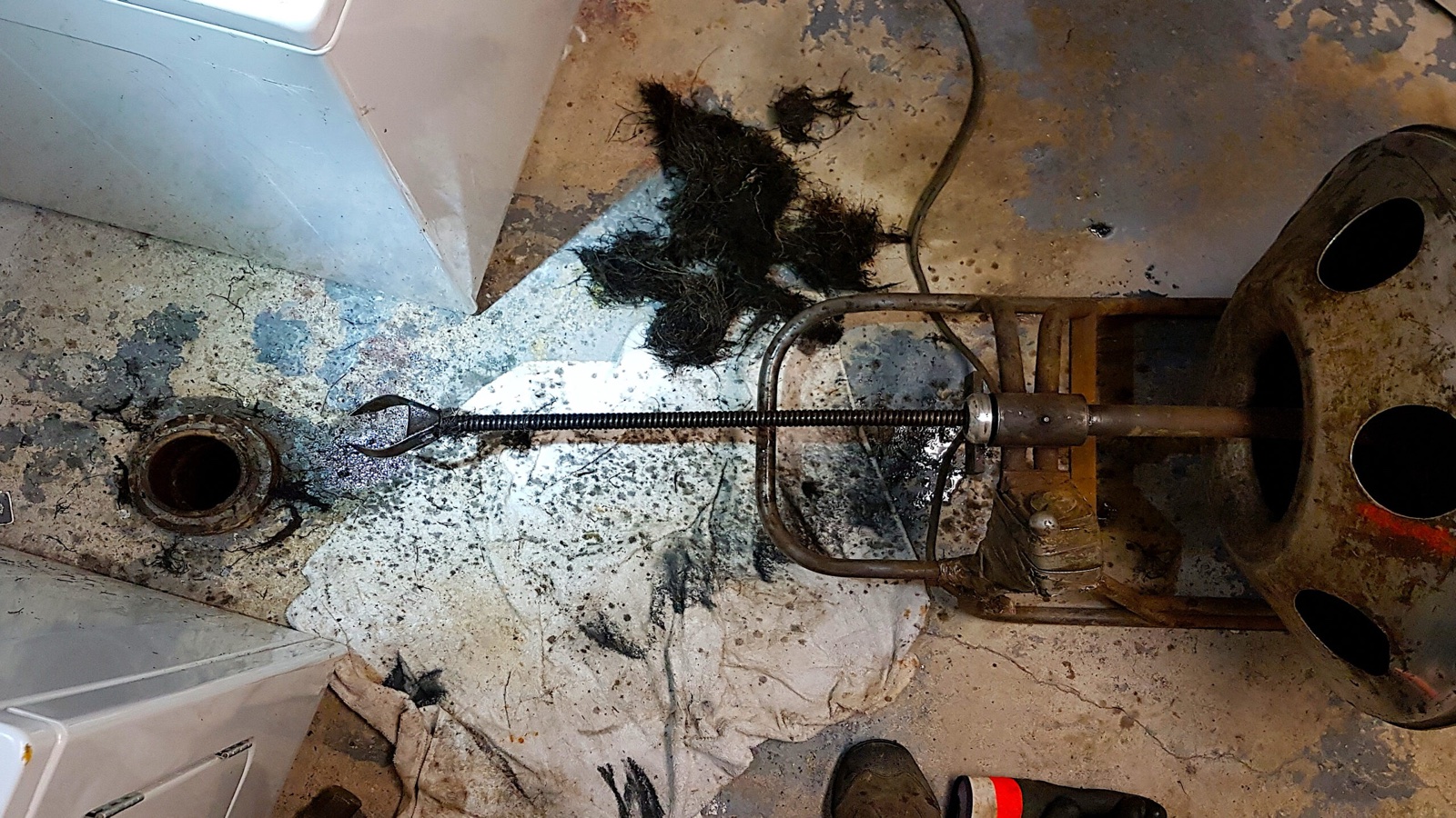 Drain-clearing cable removing a heavy root obstruction from a residential line